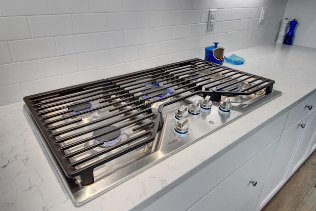 2557 Hatch Dr, Johns Island, SC 29455 - details with light stone counters, decorative backsplash, and stainless steel gas cooktop