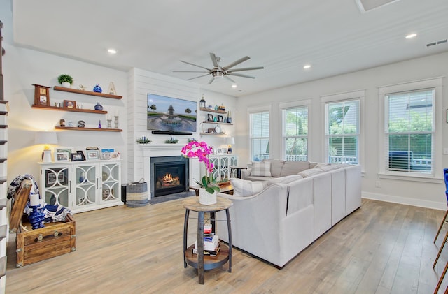 2557 Hatch Dr, Johns Island, SC 29455 - living room with ceiling fan, visible vents, a glass covered fireplace, and light wood-style floors