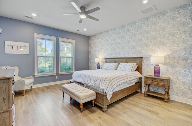 2557 Hatch Dr, Johns Island, SC 29455 - bedroom featuring visible vents, an accent wall, baseboards, light wood-style floors, and wallpapered walls