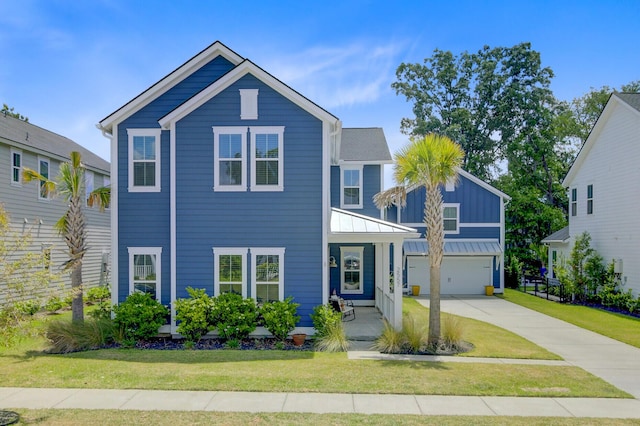 2557 Hatch Dr, Johns Island, SC 29455 - view of front facade featuring concrete driveway, board and batten siding, a front yard, and a garage