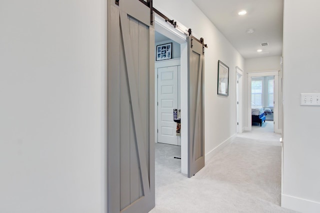 2557 Hatch Dr, Johns Island, SC 29455 - hall with light colored carpet, a barn door, recessed lighting, baseboards, and visible vents