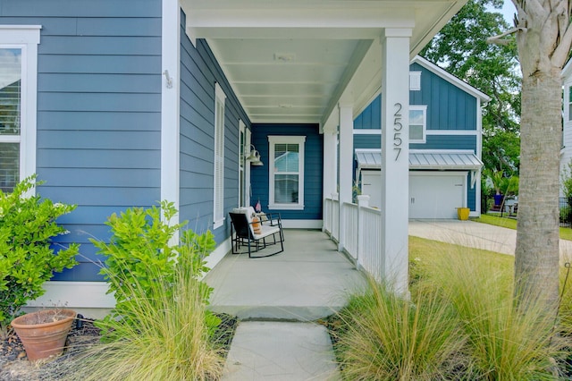2557 Hatch Dr, Johns Island, SC 29455 - entrance to property featuring covered porch, driveway, and a garage