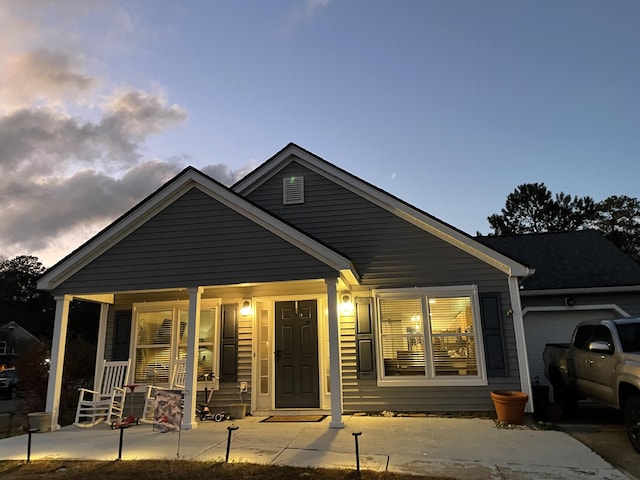 view of front of property with a garage and a porch