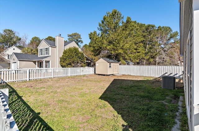 view of yard featuring central AC unit and a shed