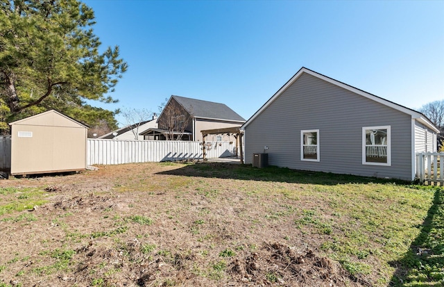 view of yard featuring central AC and a shed