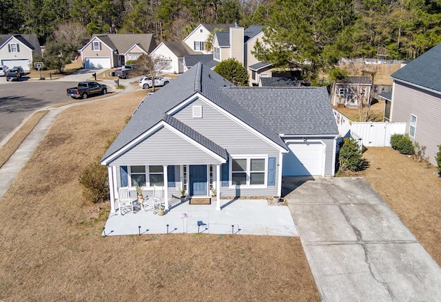 view of front of house featuring a garage, a front lawn, and a porch