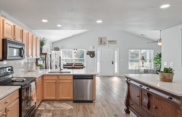 kitchen with ceiling fan, lofted ceiling, light hardwood / wood-style floors, black appliances, and sink