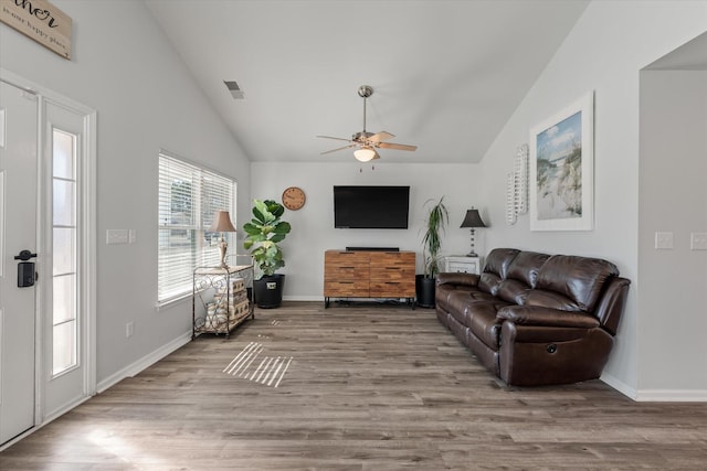 living room featuring vaulted ceiling, ceiling fan, and light hardwood / wood-style floors