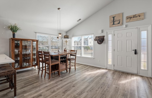 dining area with hardwood / wood-style flooring and lofted ceiling