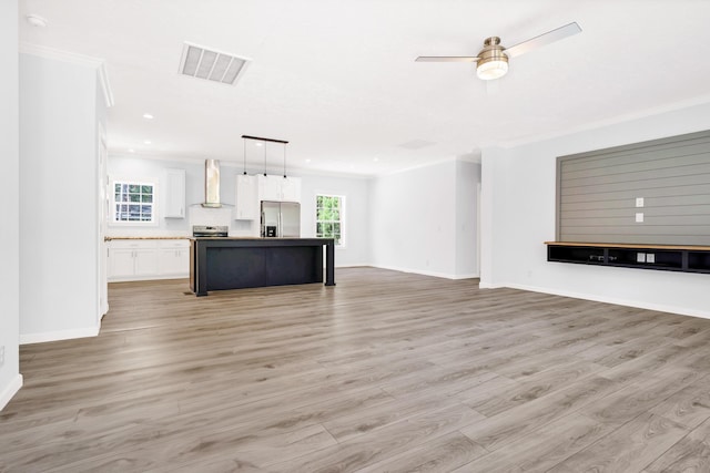 183 Waverly Rd, Walterboro, SC 29488 - unfurnished living room featuring crown molding, a ceiling fan, baseboards, light wood-type flooring, and visible vents