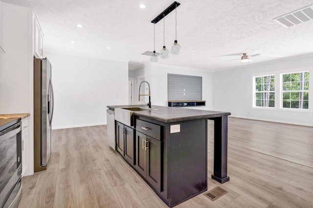 183 Waverly Rd, Walterboro, SC 29488 - kitchen with visible vents, dark countertops, ceiling fan, a sink, and stainless steel appliances