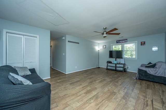 living room with wood-type flooring and ceiling fan