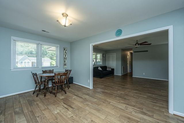 dining space with hardwood / wood-style flooring and ceiling fan