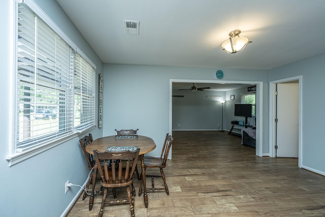 dining area with hardwood / wood-style flooring and ceiling fan