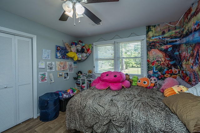 bedroom with a closet, ceiling fan, and hardwood / wood-style floors