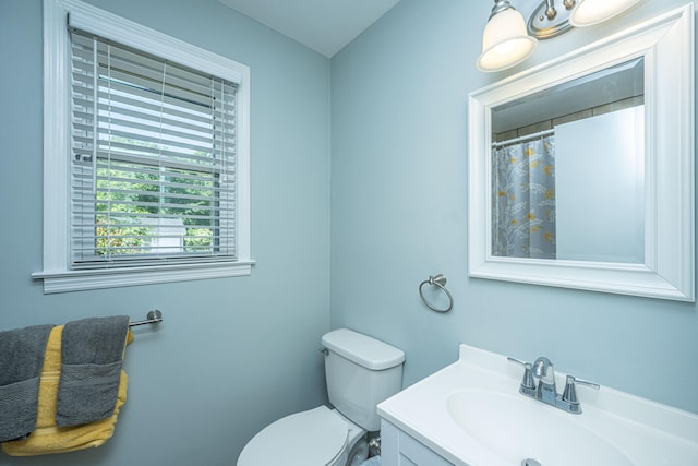 bathroom featuring toilet and vanity