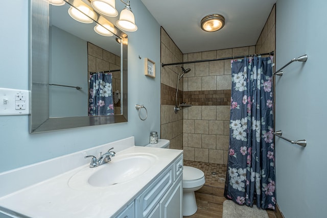 bathroom with vanity, hardwood / wood-style floors, toilet, and walk in shower