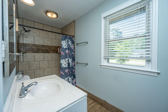 bathroom featuring sink and curtained shower