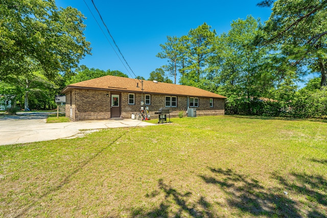 back of house featuring a patio area, central air condition unit, and a lawn