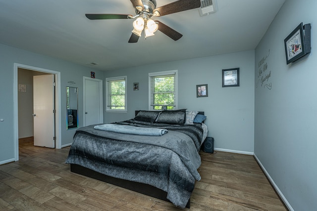 bedroom with hardwood / wood-style flooring and ceiling fan