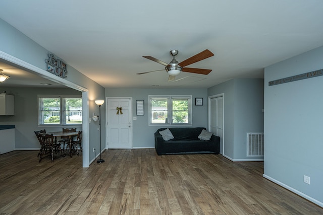 unfurnished living room featuring hardwood / wood-style flooring, a healthy amount of sunlight, and ceiling fan