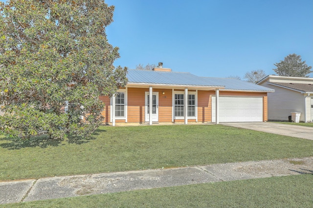 view of front of home featuring a garage and a front lawn