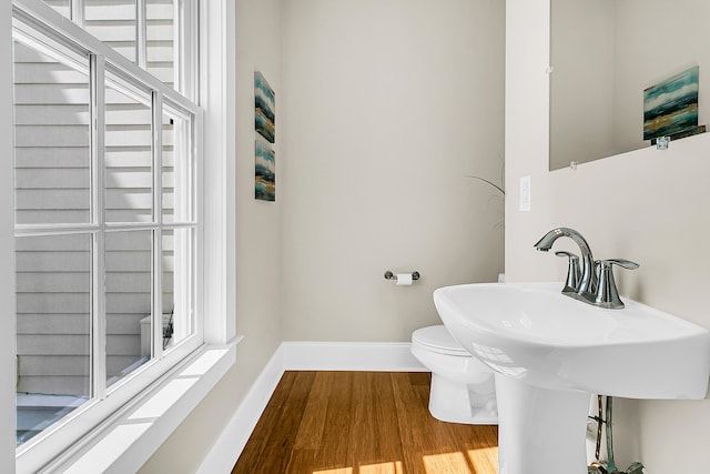 bathroom featuring hardwood / wood-style floors and toilet