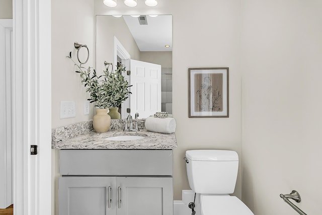 bathroom with vanity and toilet