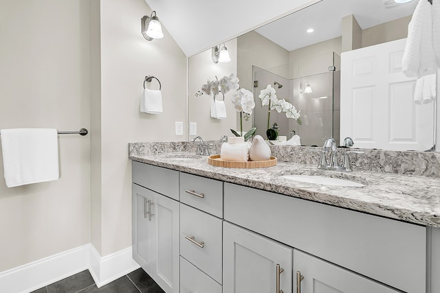 bathroom with lofted ceiling, tile patterned flooring, an enclosed shower, and vanity