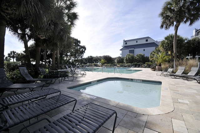 community pool featuring a patio area