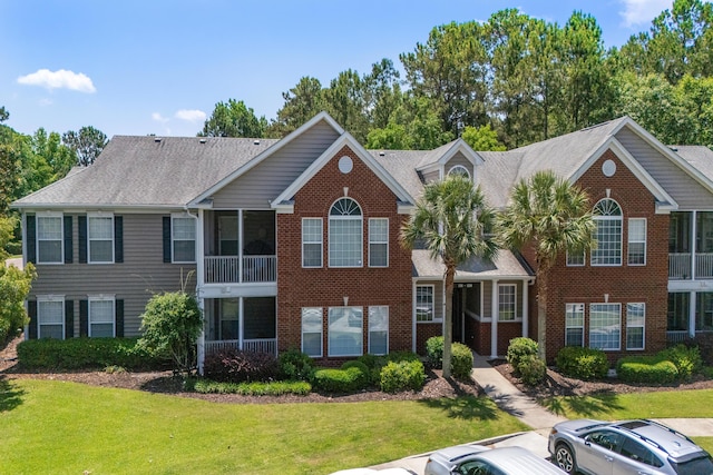 1335 Hopton Cir Unit 1335, Mount Pleasant, SC 29466 - view of front facade with a front lawn, brick siding, and roof with shingles