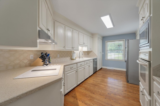 44 S Basilica Ave, Hanahan, SC 29410 - kitchen featuring appliances with stainless steel finishes, under cabinet range hood, white cabinets, and light countertops