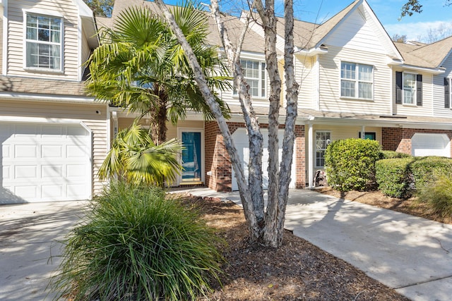 8653 Grassy Oak Trl, North Charleston, SC 29420 - townhome / multi-family property with driveway, roof with shingles, an attached garage, and brick siding