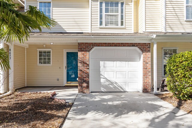 8653 Grassy Oak Trl, North Charleston, SC 29420 - view of front of property with driveway, brick siding, and a garage