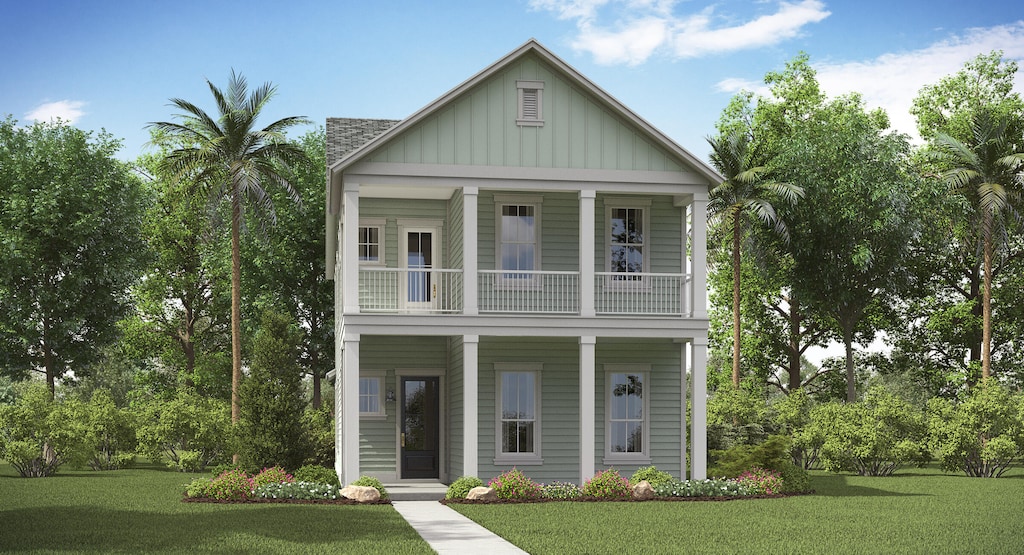 view of front of property with a balcony and a front lawn