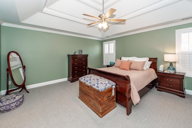 carpeted bedroom featuring visible vents, a raised ceiling, baseboards, and crown molding