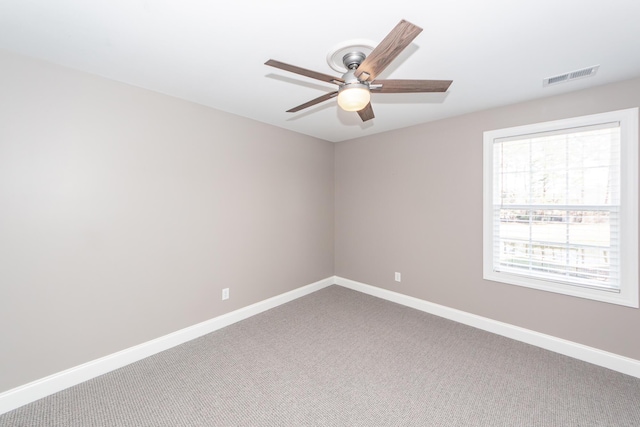 empty room featuring a ceiling fan, carpet flooring, baseboards, and visible vents