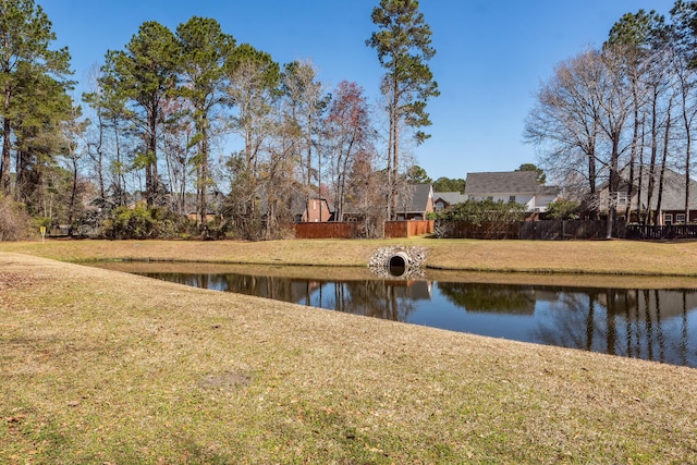 exterior space featuring a water view and fence