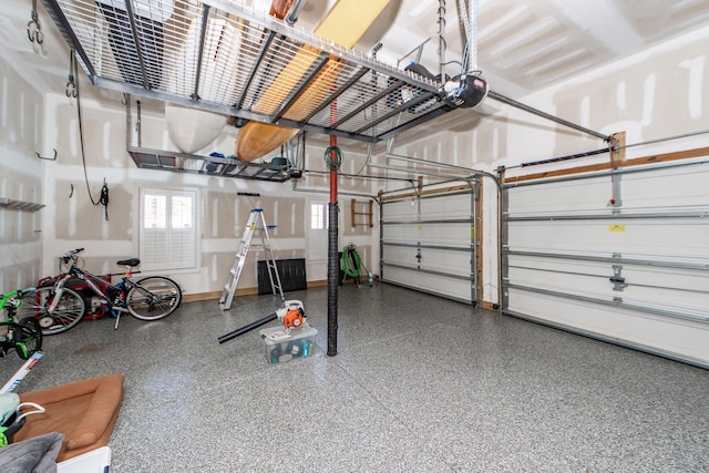 garage with baseboards and a garage door opener