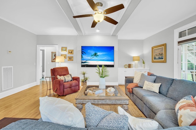 living area featuring beam ceiling, light wood-style floors, a ceiling fan, baseboards, and ornamental molding