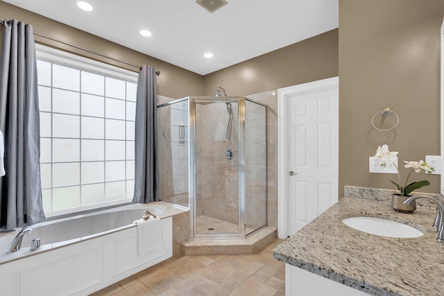 full bathroom with a stall shower, a bath, vanity, and recessed lighting