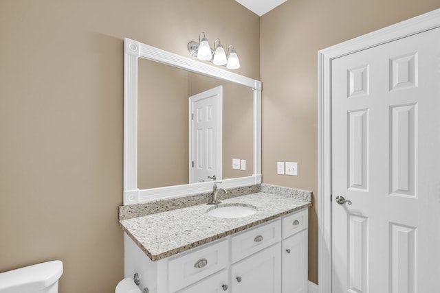 half bathroom featuring toilet and vanity
