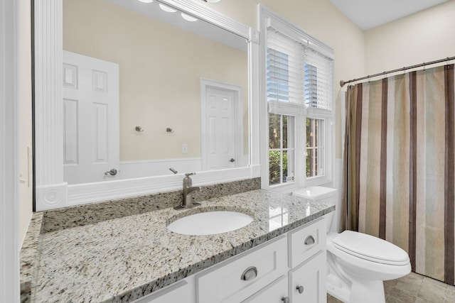full bath featuring toilet, vanity, and a shower with shower curtain
