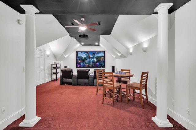 carpeted cinema room featuring decorative columns, a ceiling fan, baseboards, and vaulted ceiling