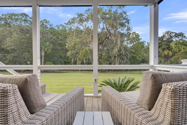 sunroom / solarium with view of scattered trees and plenty of natural light