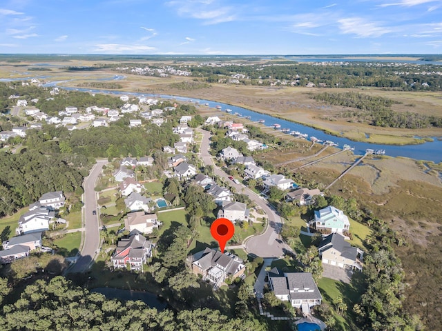 aerial view of property and surrounding area with a large body of water and nearby suburban area