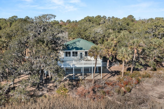 rear view of house featuring a wooden deck