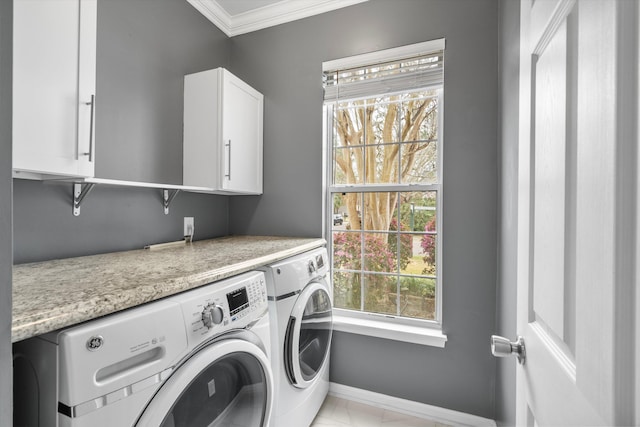 laundry room featuring washing machine and dryer, cabinet space, baseboards, and ornamental molding