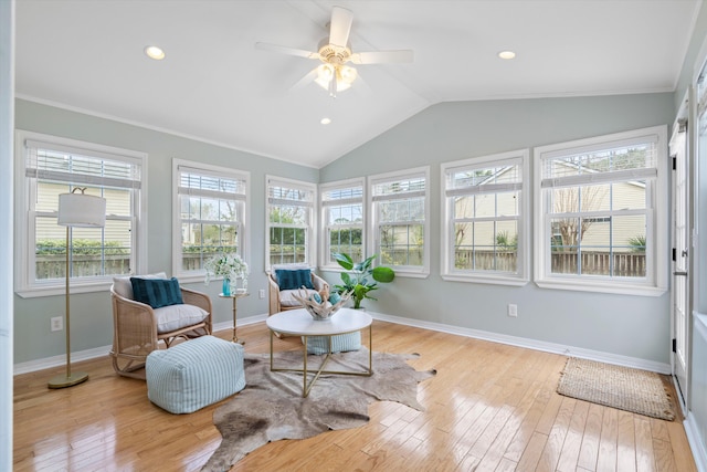 sunroom with a ceiling fan and vaulted ceiling