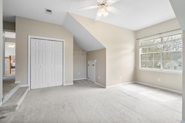 unfurnished bedroom with visible vents, light colored carpet, a closet, and baseboards